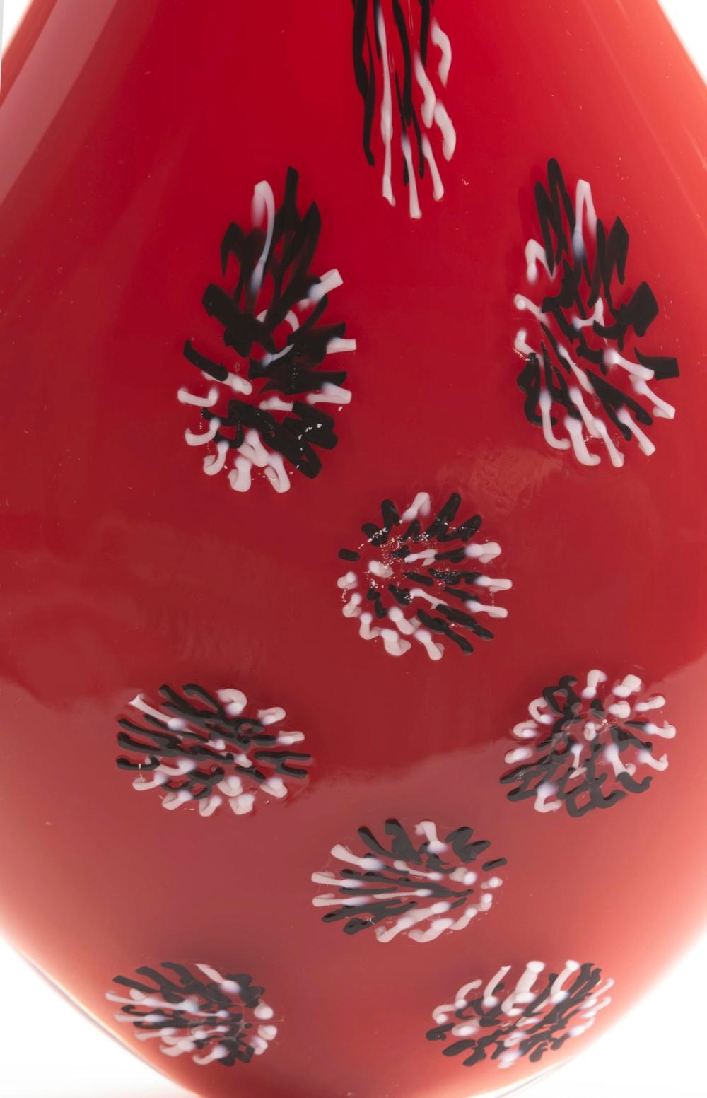 Artwork by Steve Funk, Vase, Made of iron red blown glass with black and white stylized rosettes on front of flattened body