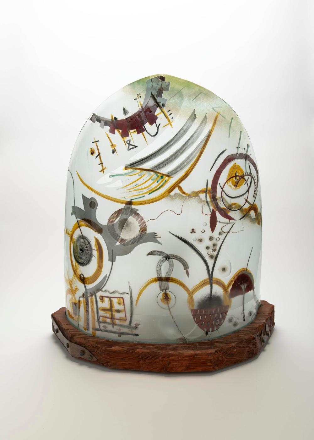 Artwork by Peter Mangan, Lamp, Made of glass with multi colored abstract inclusions designs, upon a wood base with metal fittings
