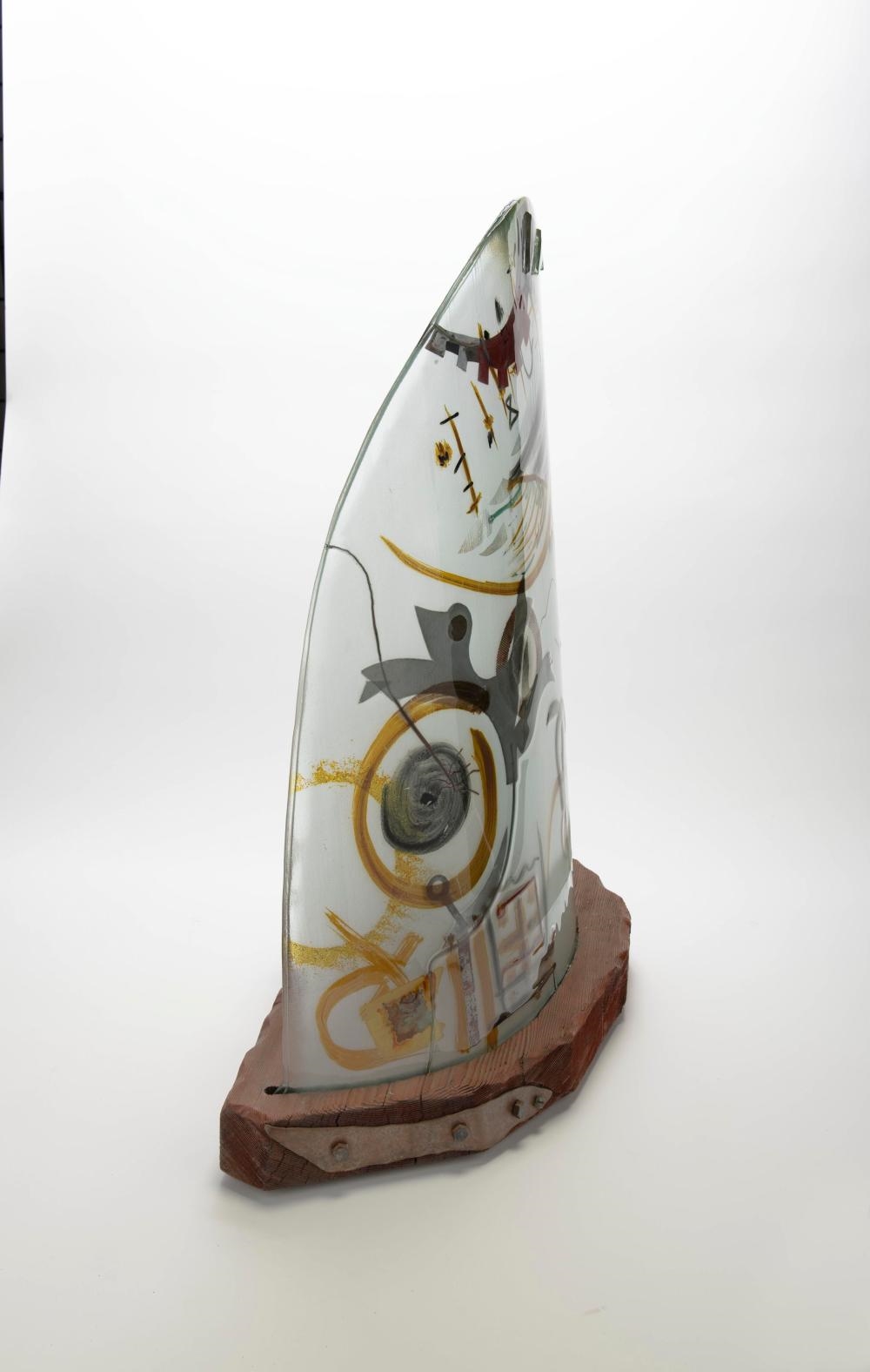 Artwork by Peter Mangan, Lamp, Made of glass with multi colored abstract inclusions designs, upon a wood base with metal fittings