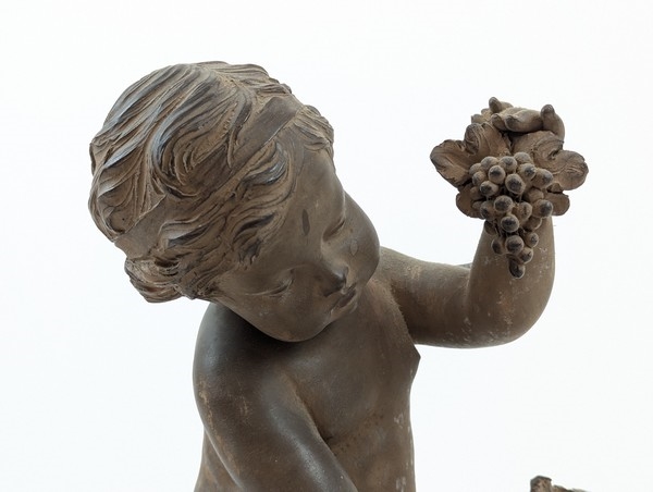 Artwork by Renè Rod, René ROD (XIX-XXe siècle) SCULPTURE en terre cuite dans le goût du XVIIIe représentant un enfant jouant avec une grappe de raisin. Signée Roll à l'arrière.  ;  (Manque), Made of Terracotta