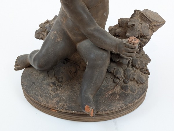 Artwork by Renè Rod, René ROD (XIX-XXe siècle) SCULPTURE en terre cuite dans le goût du XVIIIe représentant un enfant jouant avec une grappe de raisin. Signée Roll à l'arrière.  ;  (Manque), Made of Terracotta