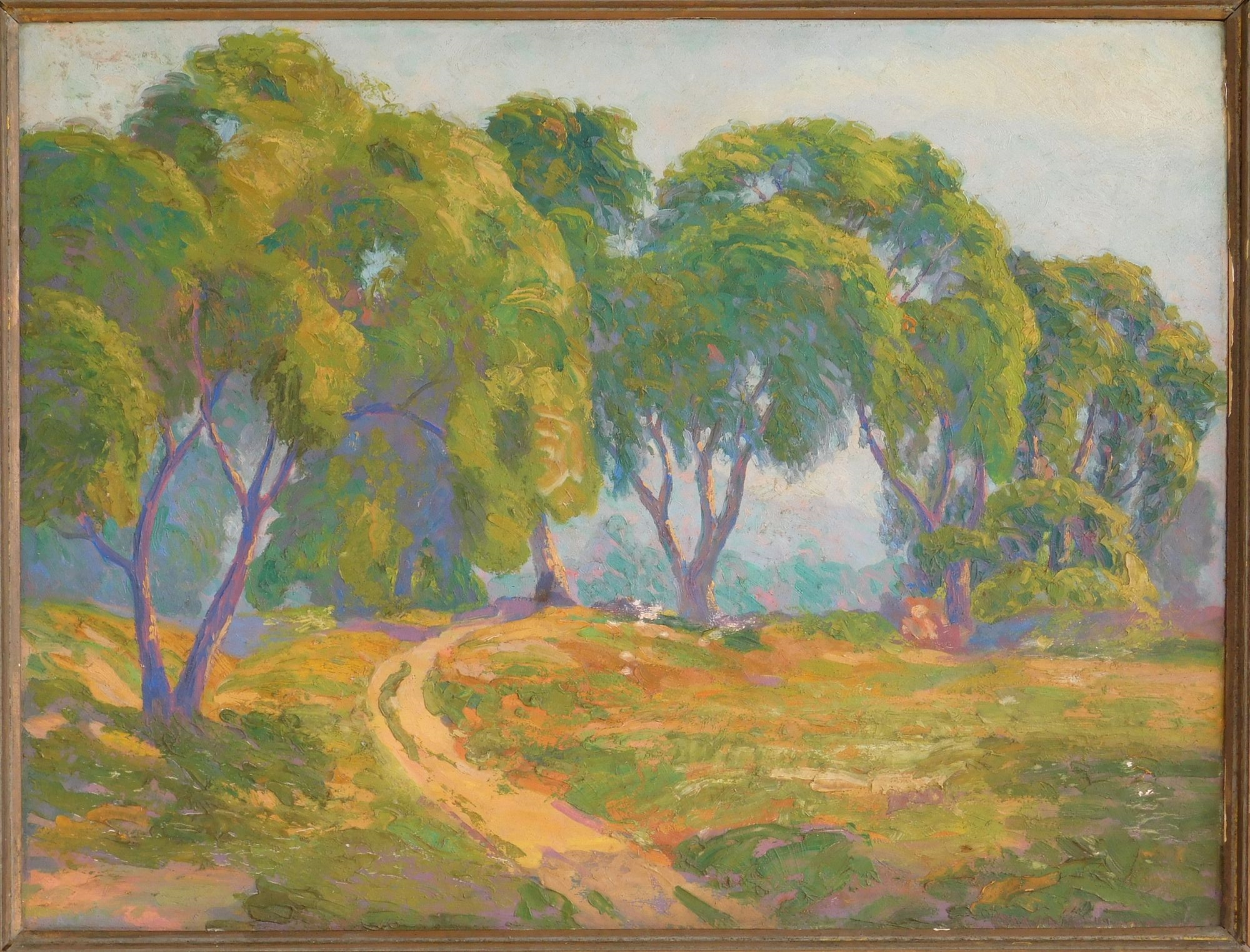 A framed landscape painting of a sunlit path winding through green trees.