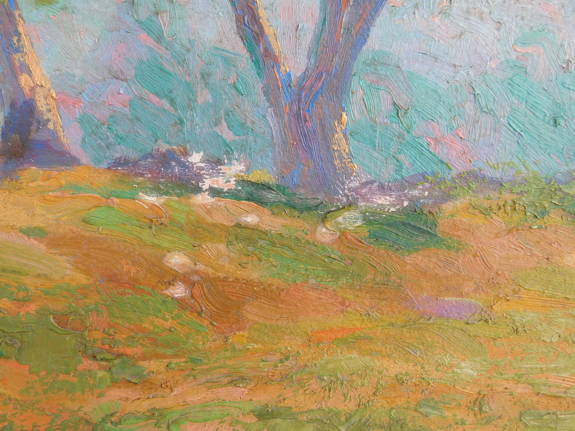 A framed landscape painting of a sunlit path winding through green trees.