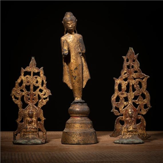 A BRONZE FIGURE OF STANDING BUDDHA AND TWO GILT-BRONZE ALTAR ORNAMENTS by Thai School, 19th Century, 19. Jh