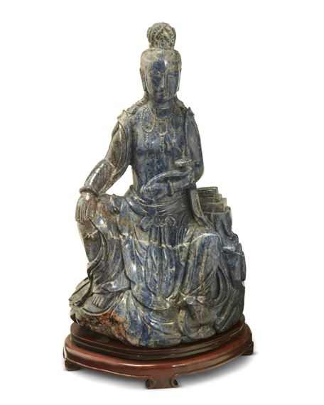A Chinese carved lapis figure of a seated Guanyin