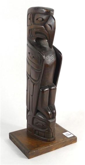 A carved wood totem pole with raven - Danny Matilpi