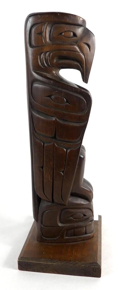 Artwork by Danny Matilpi, A carved wood totem pole with raven, Made of carved wood