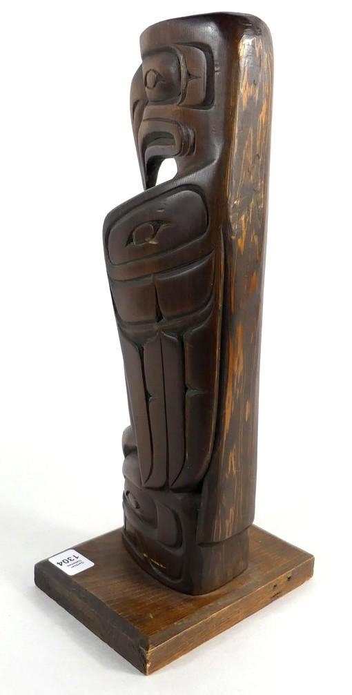 Artwork by Danny Matilpi, A carved wood totem pole with raven, Made of carved wood
