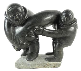 A large-scale soapstone figural group carved in the form of two Inuit hunters holding seal - Markusi Kuanana