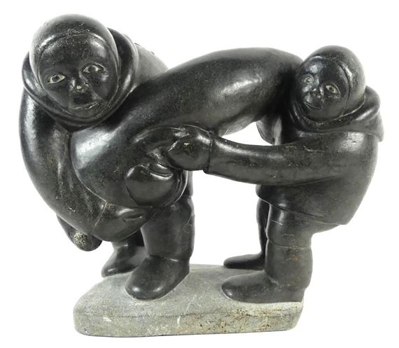A large-scale soapstone figural group carved in the form of two Inuit hunters holding seal - Markusi Kuanana