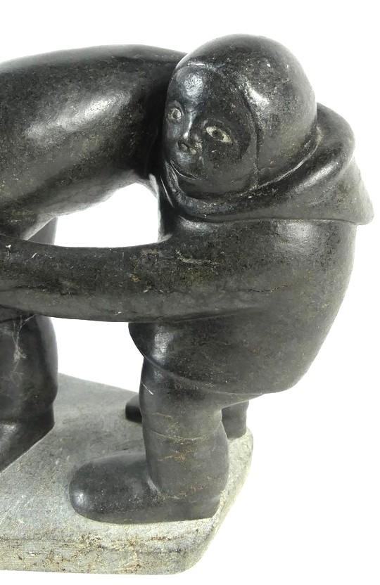 Artwork by Markusi Kuanana, A large-scale soapstone figural group carved in the form of two Inuit hunters holding seal, Made of soapstone