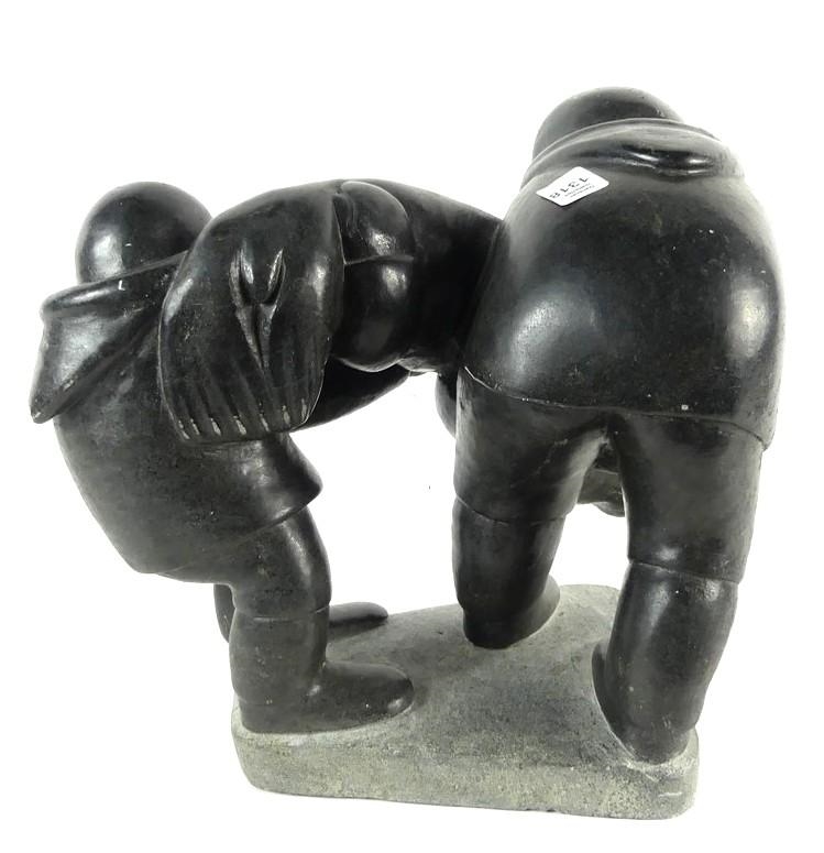 Artwork by Markusi Kuanana, A large-scale soapstone figural group carved in the form of two Inuit hunters holding seal, Made of soapstone