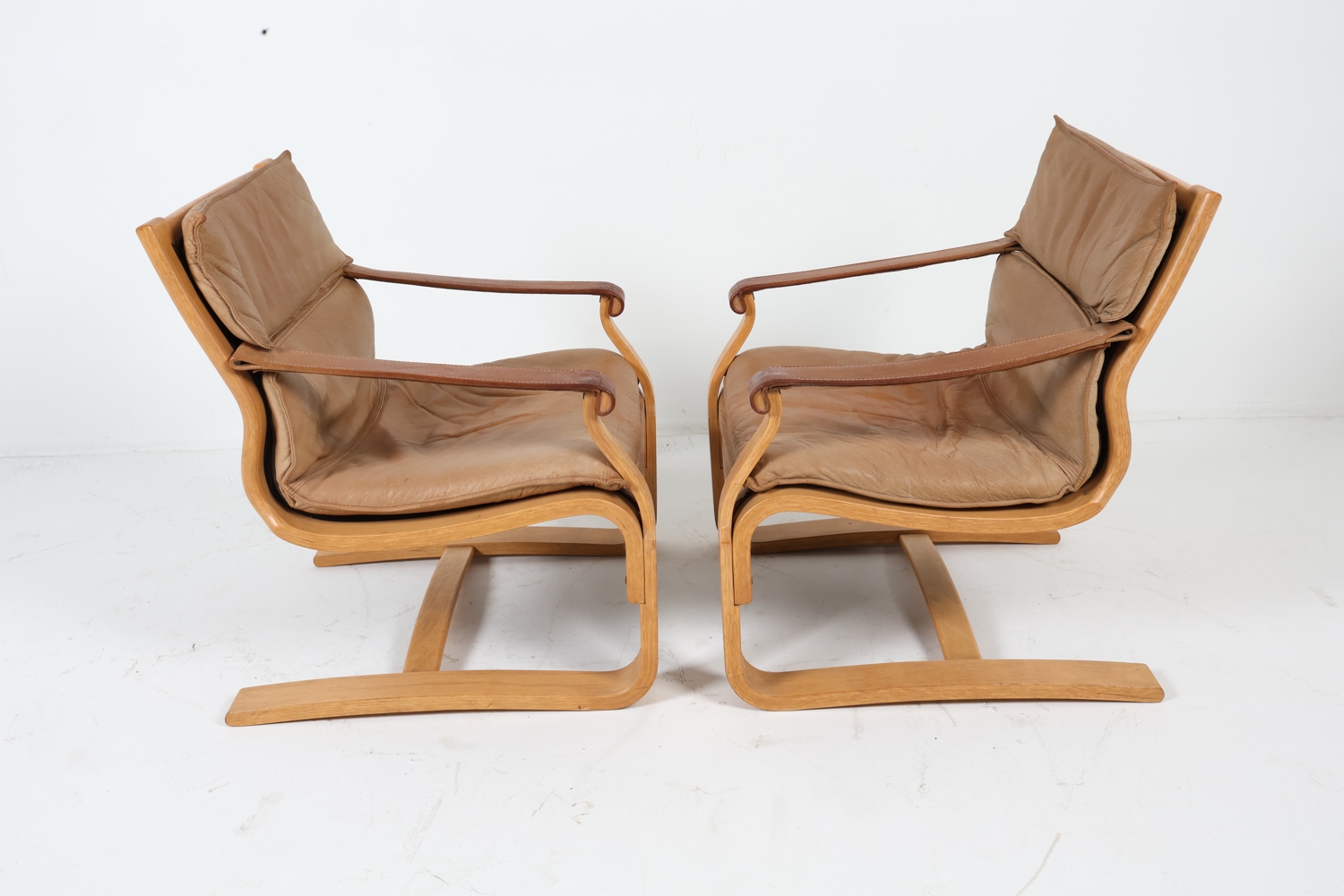 Artwork by Ake Fribyter, ATTR. AKE FRIBYTTER LEATHER LOUNGE CHAIRS C. 1970S, Made of bentwood frames with tan leather upholstery