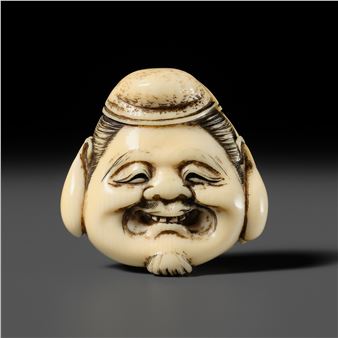 TOSHINSAI MITSUHIRO: A FINE IVORY NETSUKE OF A DAIKOKU MASK WITH A HIDDEN SHUNGA INTERIOR - Toshinsai Mitsuhiro