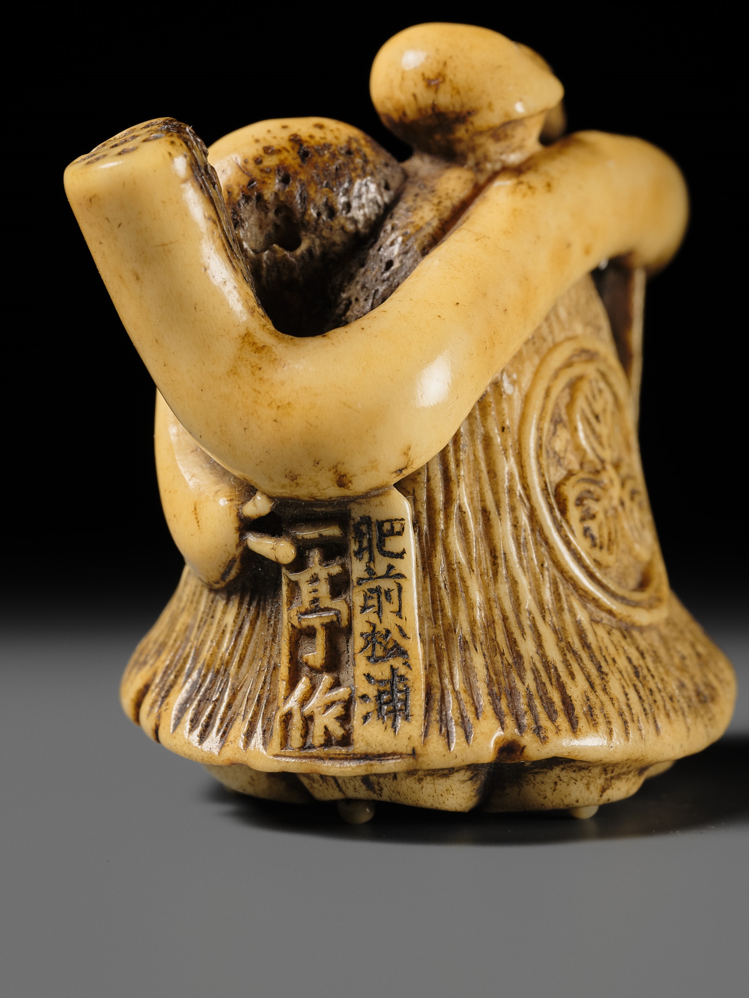Artwork by Hizen Matsura Ittei, ITTEI: AN ANTLER (TRICK) NETSUKE OF A LOTUS POD WITH THE MAKINO CLAN MON, Made of plaque