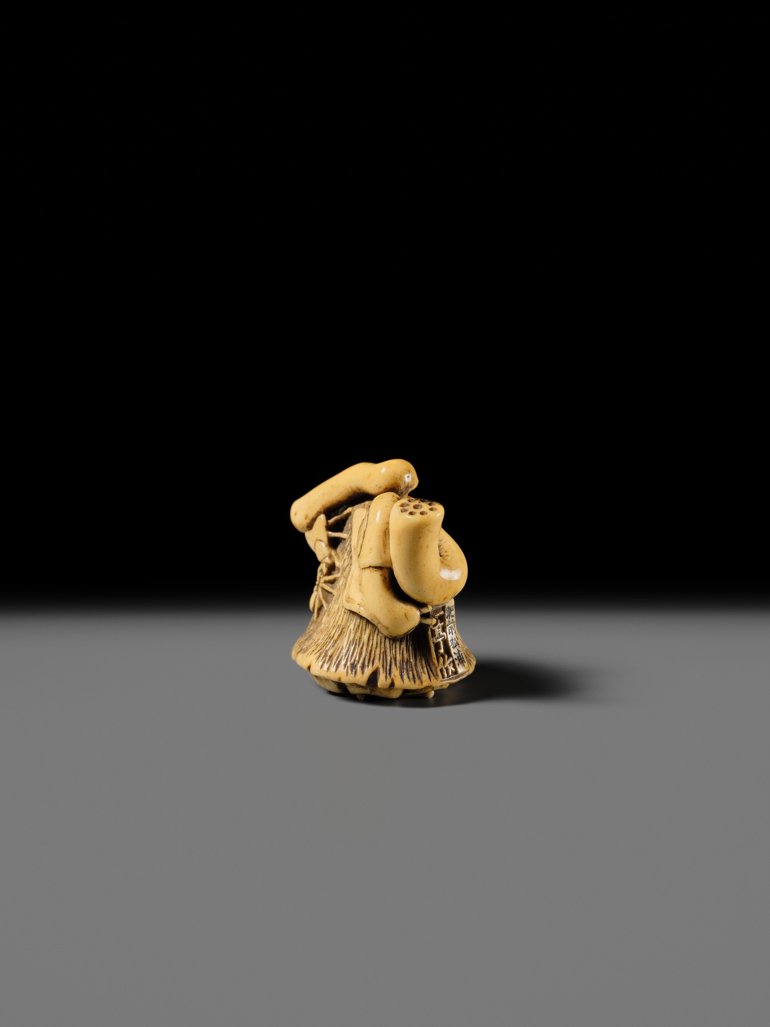 Artwork by Hizen Matsura Ittei, ITTEI: AN ANTLER (TRICK) NETSUKE OF A LOTUS POD WITH THE MAKINO CLAN MON, Made of plaque