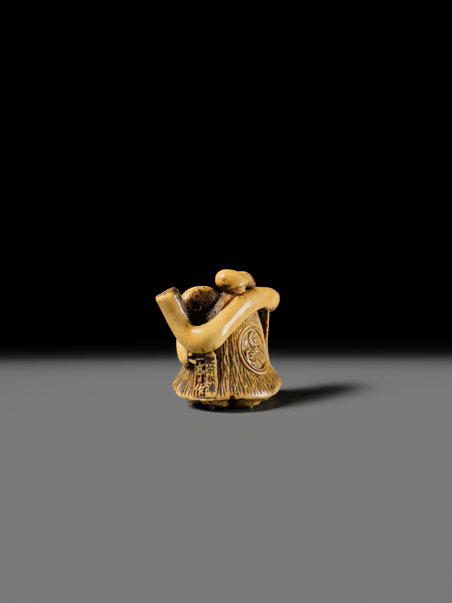 Artwork by Hizen Matsura Ittei, ITTEI: AN ANTLER (TRICK) NETSUKE OF A LOTUS POD WITH THE MAKINO CLAN MON, Made of plaque