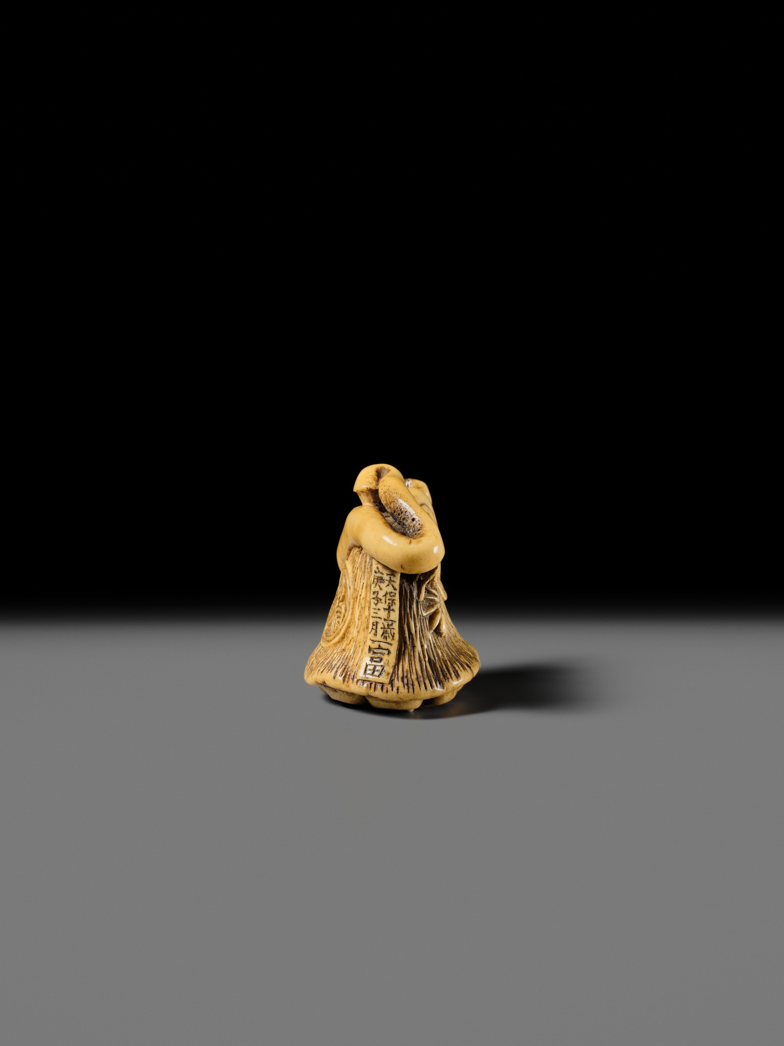 Artwork by Hizen Matsura Ittei, ITTEI: AN ANTLER (TRICK) NETSUKE OF A LOTUS POD WITH THE MAKINO CLAN MON, Made of plaque