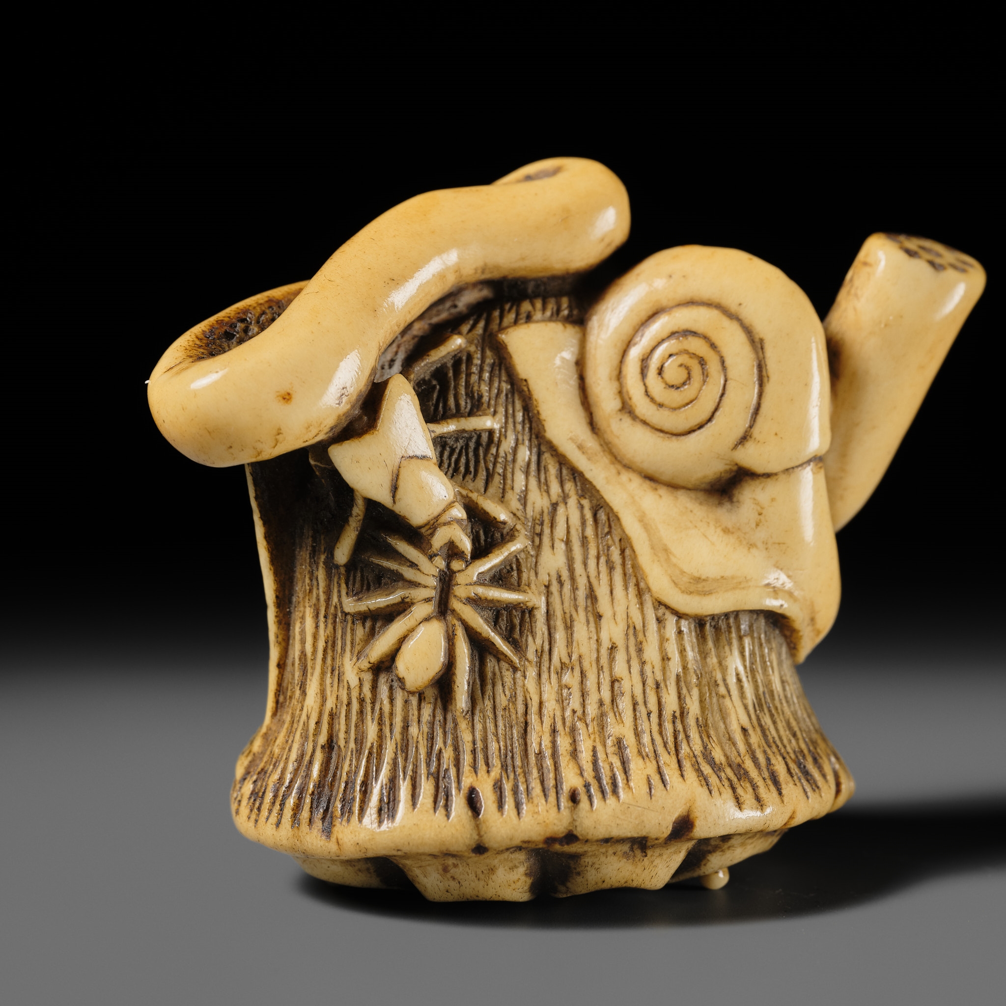 Artwork by Hizen Matsura Ittei, ITTEI: AN ANTLER (TRICK) NETSUKE OF A LOTUS POD WITH THE MAKINO CLAN MON, Made of plaque