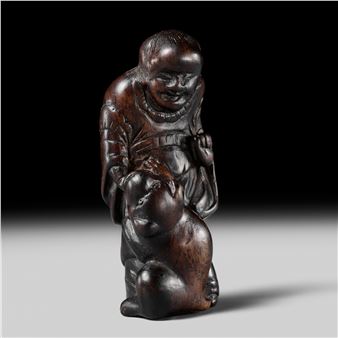 SHUGETSU: AN EBONY WOOD NETSUKE OF A CHINESE BOY WITH HIS DOG - Shugetsu