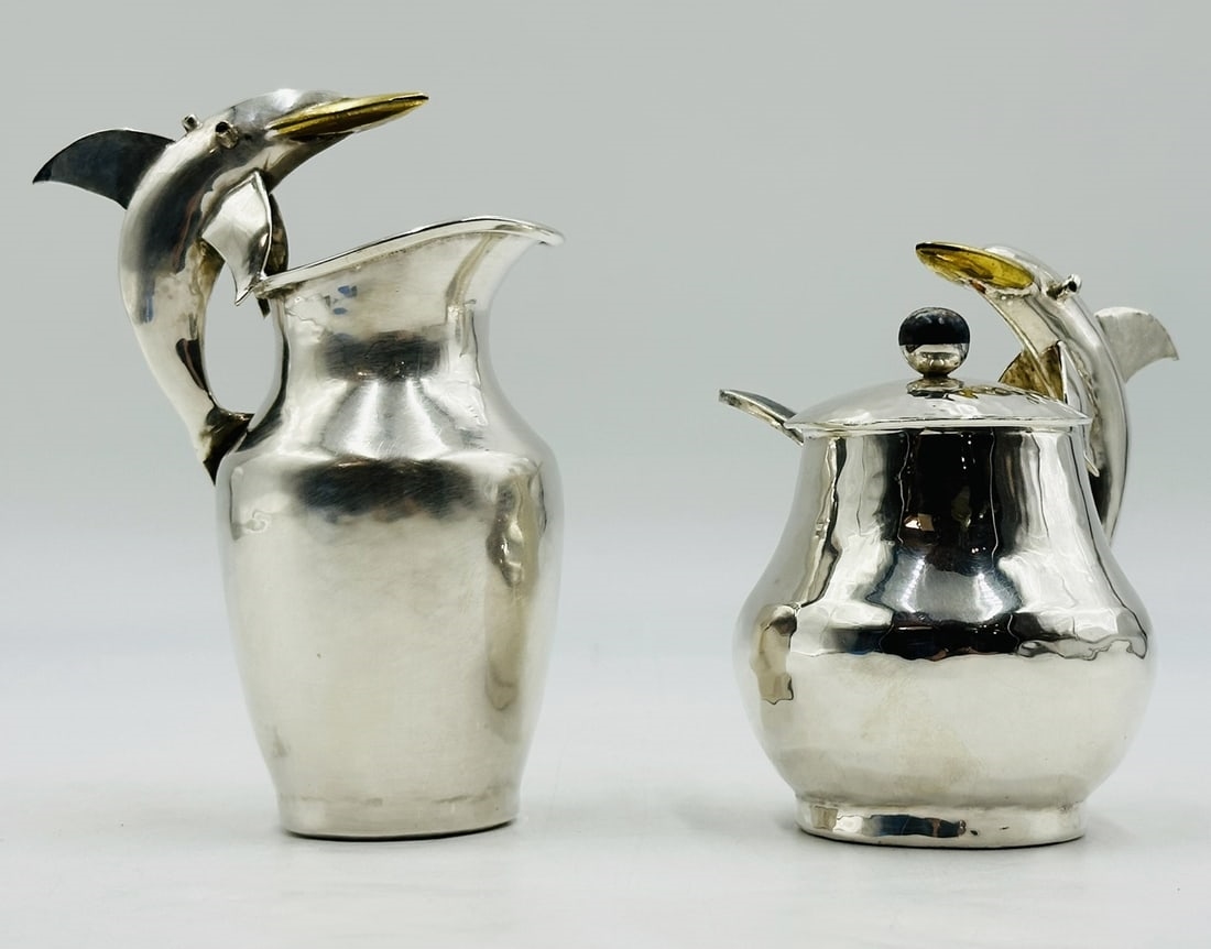 Artwork by Los Castillo, Pitcher and Lidded Pot with Dolphin Handles by Los Castillo, 20th Century Mexico, Made of silver & brass