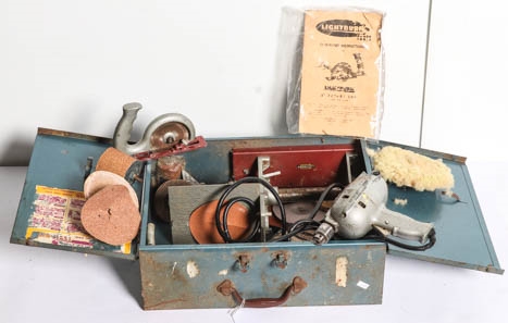 Artwork by MANUAL, A vintage Lightburn rotary saw with instruction manual in original metal case, Made of metal