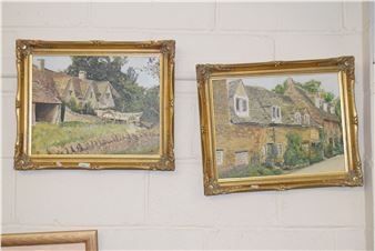 Two framed pastoral landscape paintings hang on a white brick wall.