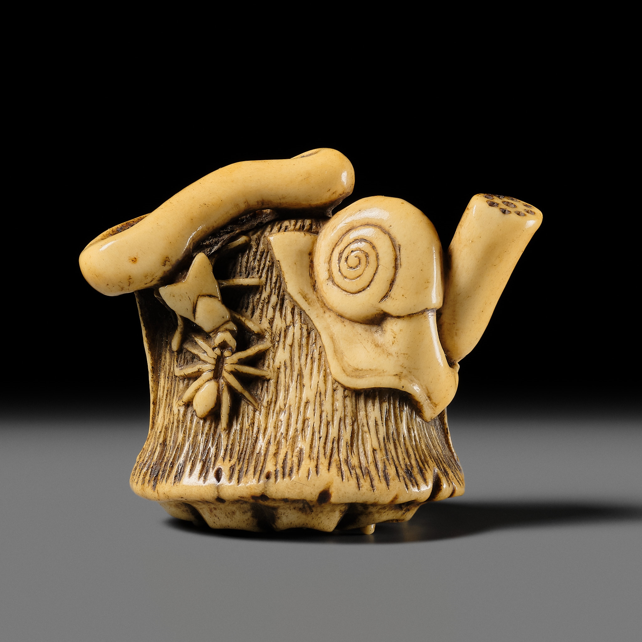 Artwork by Hizen Matsura Ittei, ITTEI: AN ANTLER (TRICK) NETSUKE OF A LOTUS POD WITH THE MAKINO CLAN MON, Made of plaque