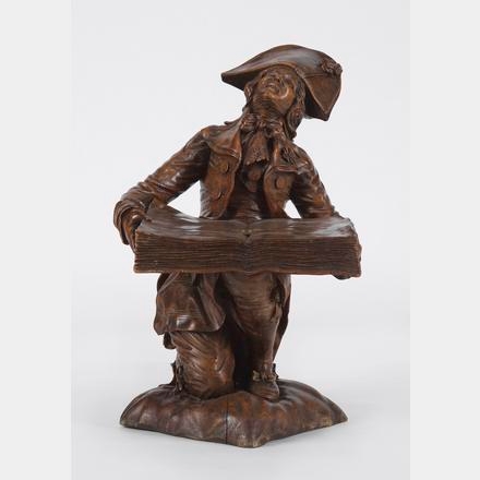 Artwork by Victor Aimone, Sellette représentant un homme portant un livre, Made of Carved wood