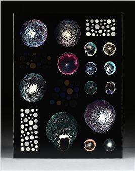 A black rectangular panel displaying an array of colorful, textured spheres and circular patterns.