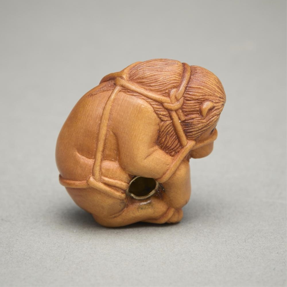 Artwork by Susan Wraight, Aslan Bound, Made of Stained European boxwood ojime carving