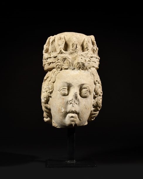 Artwork by Simon Guillain, LARGE HEAD OF A LOUIS XIII CHILD IN CARVED THUNDERBOLT LIMESTONE. Framed by a fleur-de-lys crown, Made of Carved thunderbolt limestone