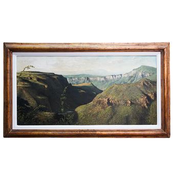 Depicting a desert landscape with deep valleys and green grass covered craggily rock peaks - Alfredo Gomez
