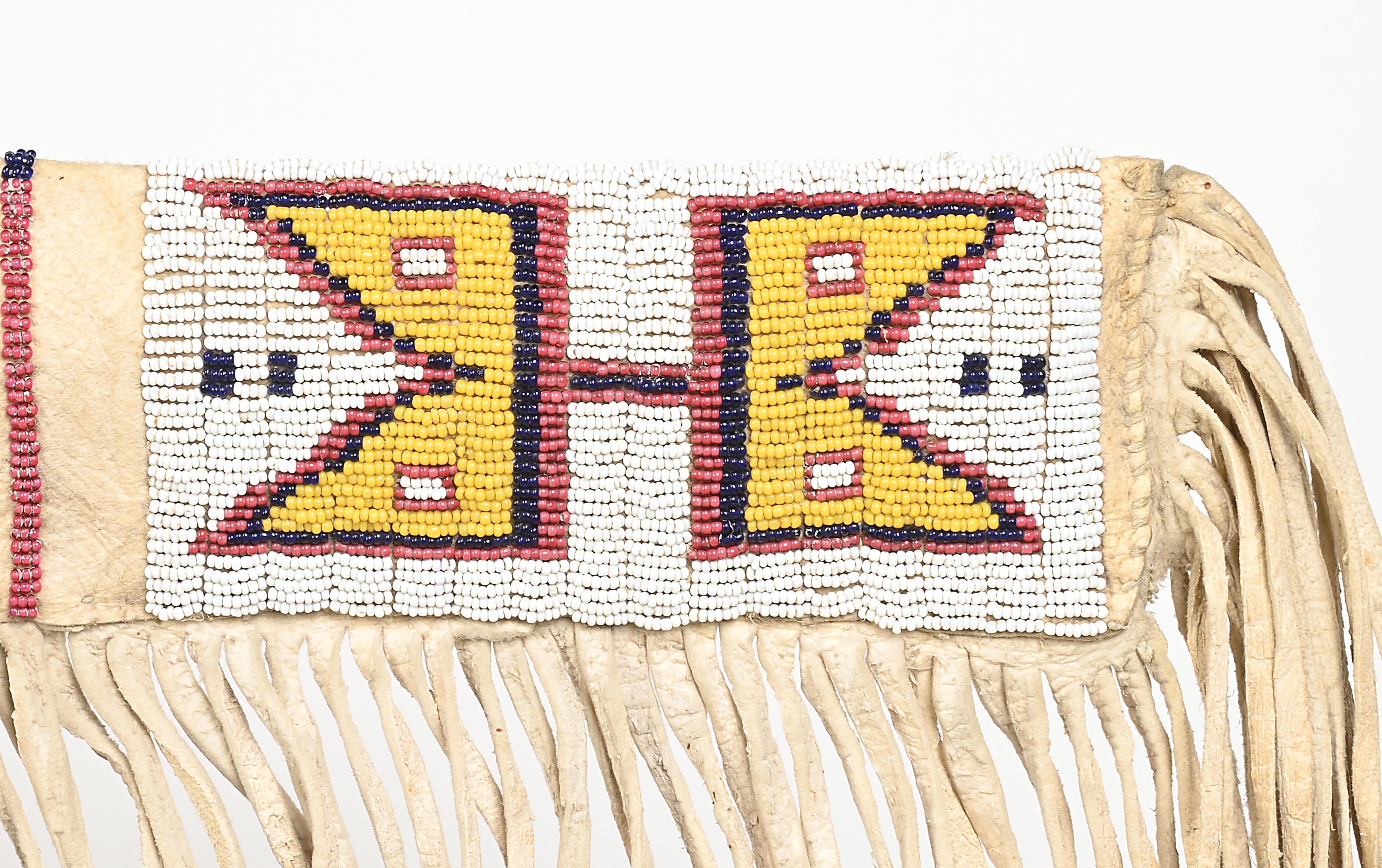 Fringe | A beaded and fringed rifle scabbard with crosses and geometric ...