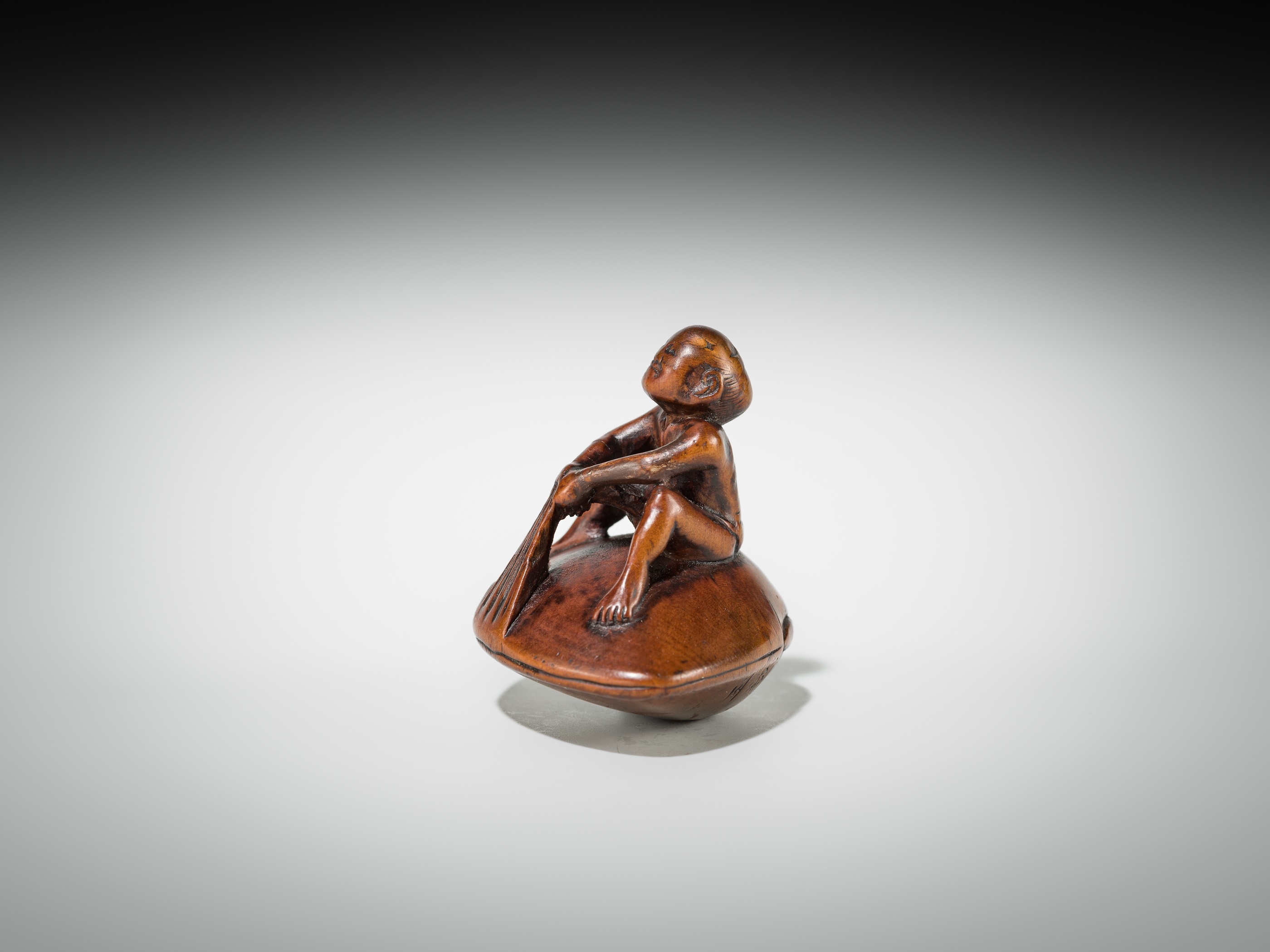 Gyokusai | GYOKUSAI: A FINE WOOD SHUNGA NETSUKE OF MAN ON A HAMAGURI ...