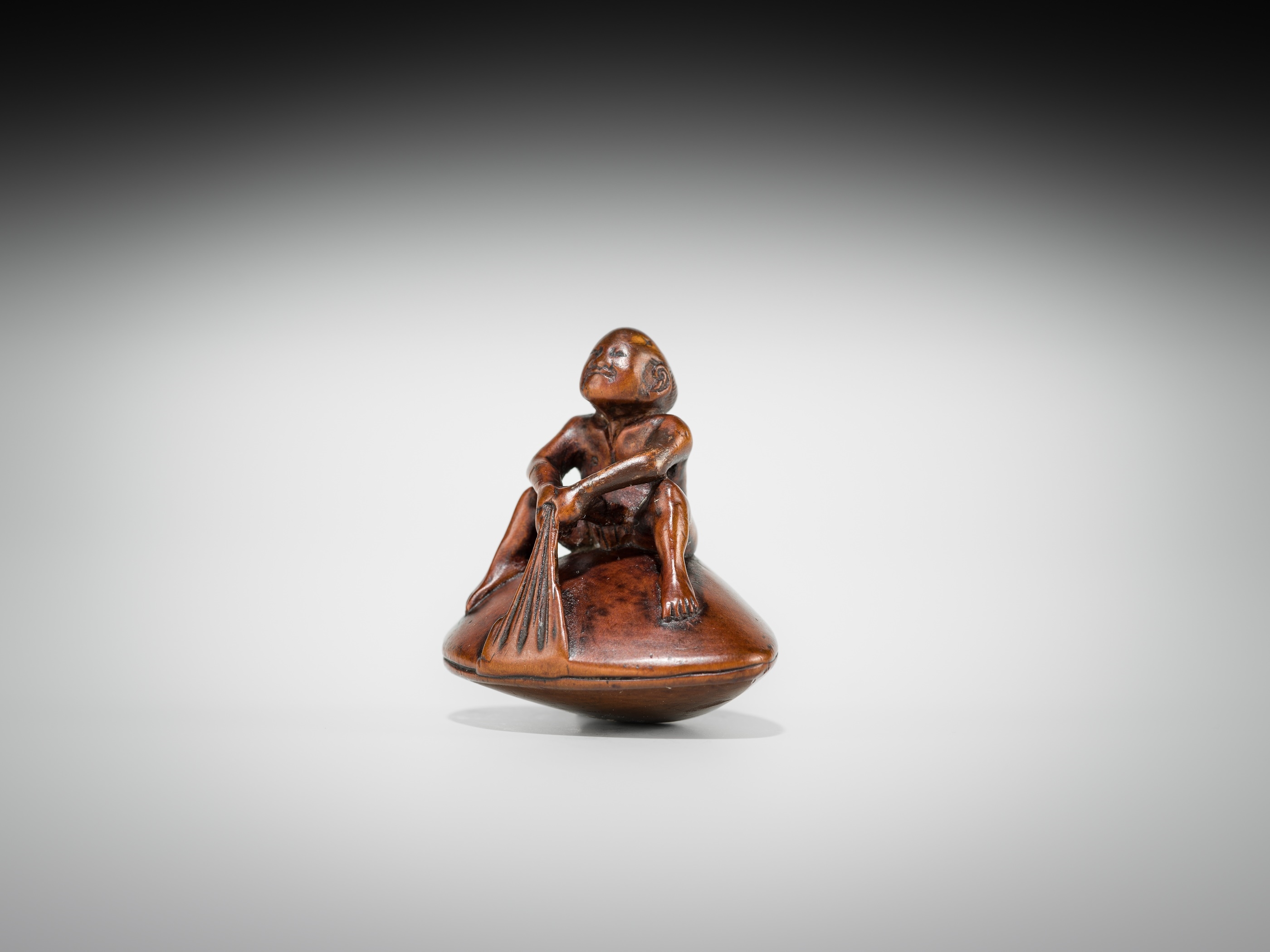 Gyokusai | GYOKUSAI: A FINE WOOD SHUNGA NETSUKE OF MAN ON A HAMAGURI ...