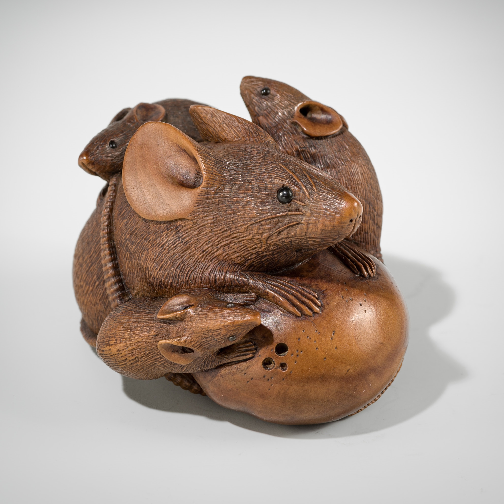 Artwork by Hokyudo Itsumin, ITSUMIN: A FINE WOOD NETSUKE OKIMONO OF A GROUP OF RATS WITH PERSIMMON, Made of wood