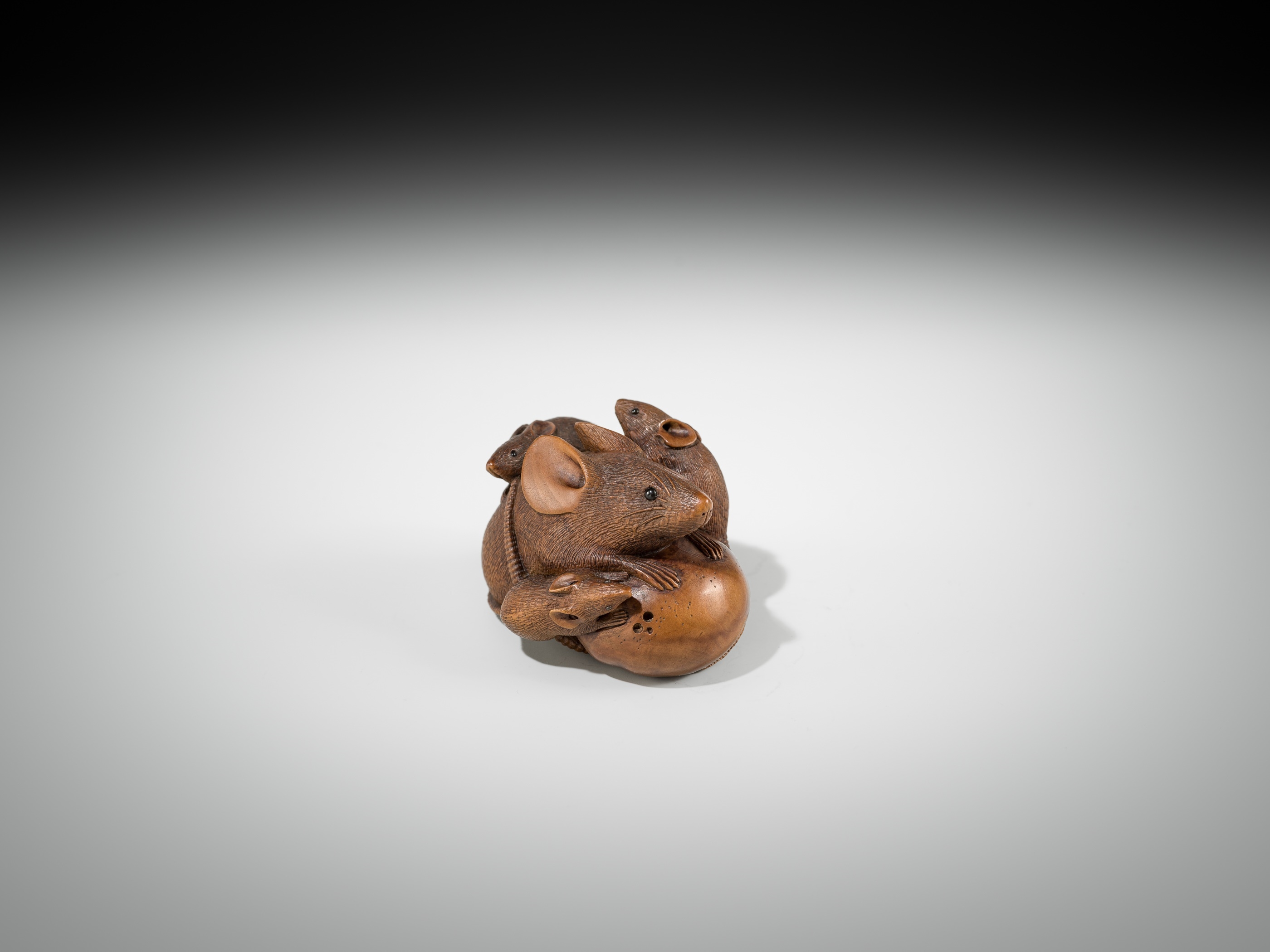 Artwork by Hokyudo Itsumin, ITSUMIN: A FINE WOOD NETSUKE OKIMONO OF A GROUP OF RATS WITH PERSIMMON, Made of wood