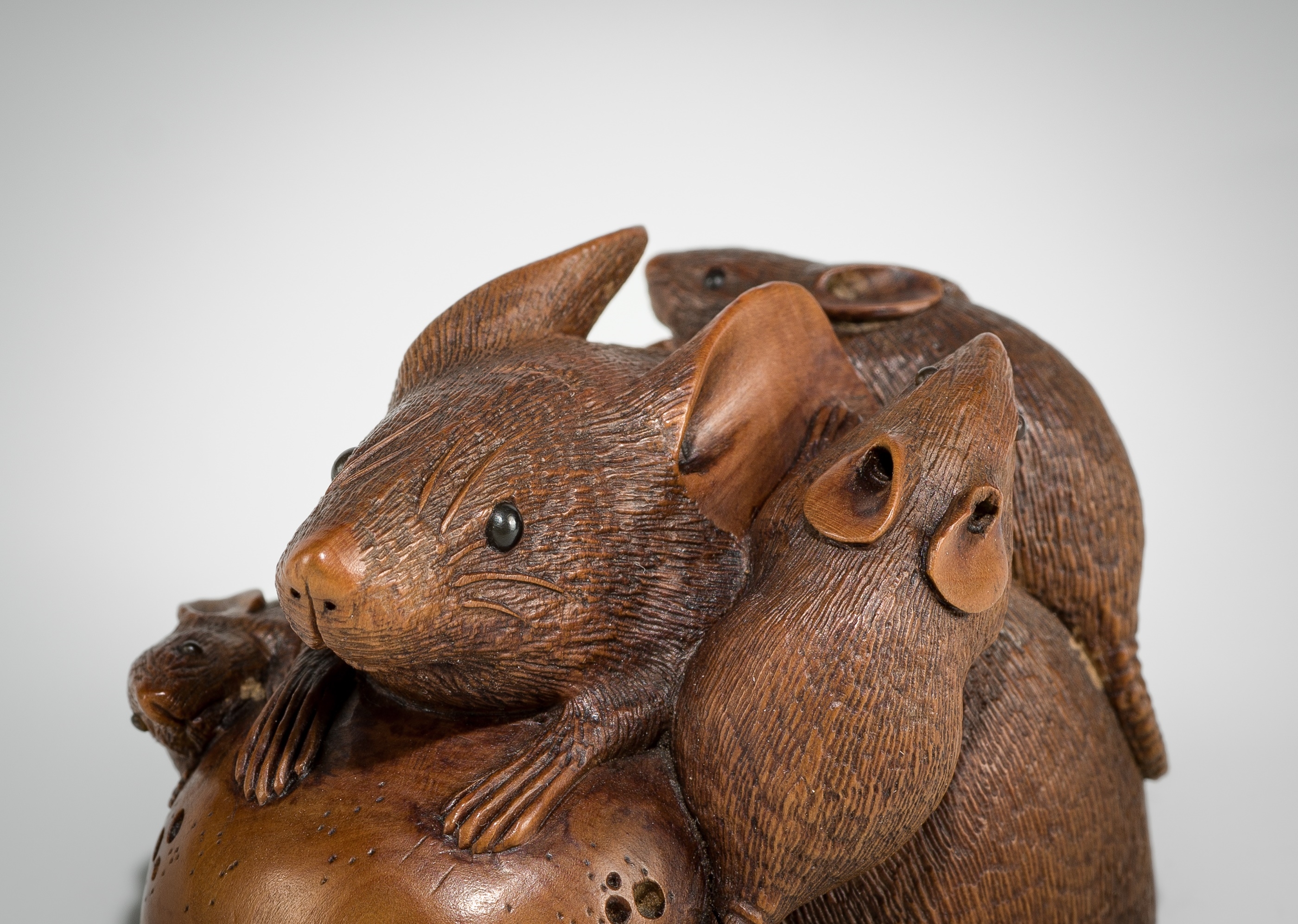 Artwork by Hokyudo Itsumin, ITSUMIN: A FINE WOOD NETSUKE OKIMONO OF A GROUP OF RATS WITH PERSIMMON, Made of wood