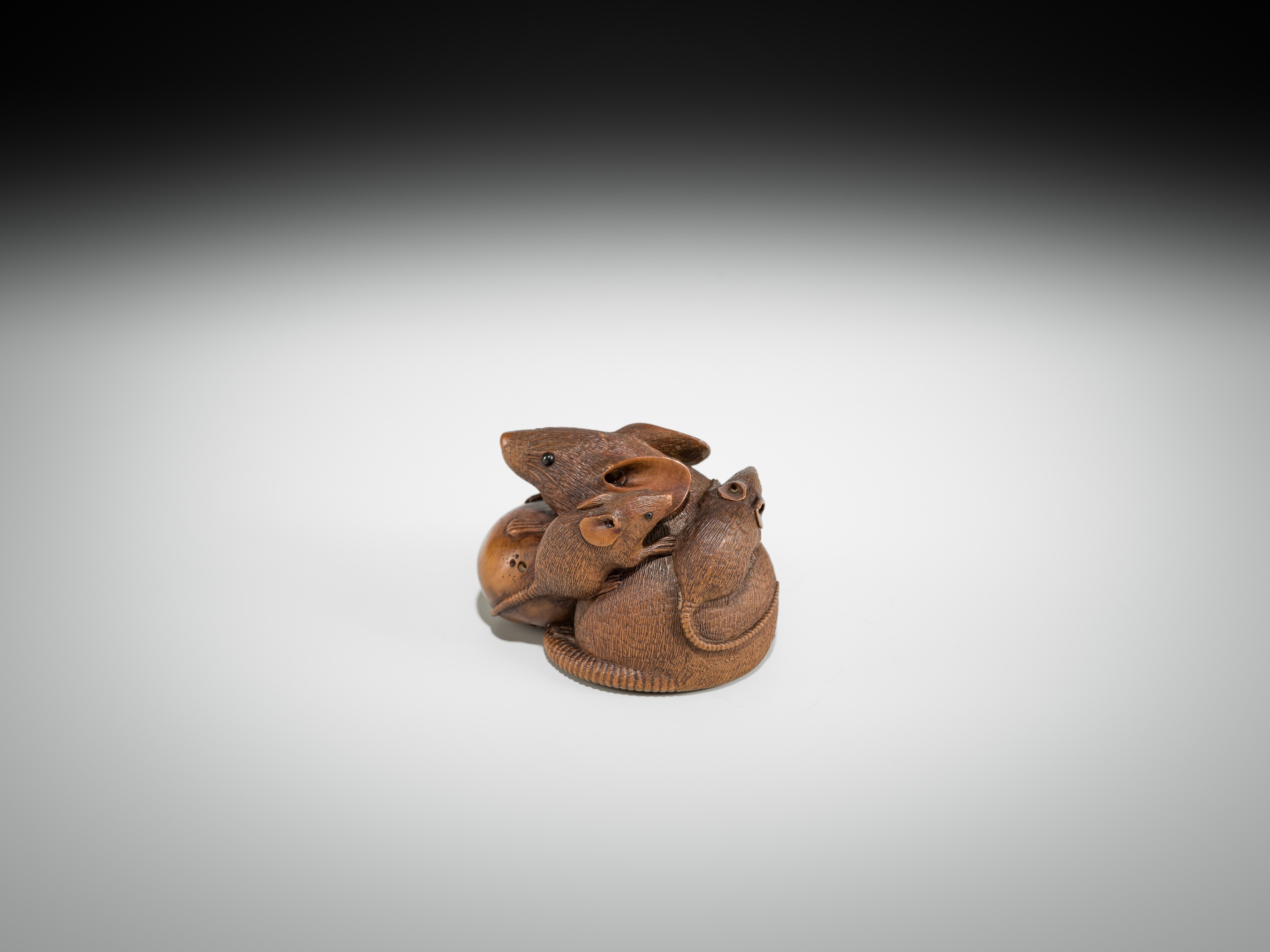 Artwork by Hokyudo Itsumin, ITSUMIN: A FINE WOOD NETSUKE OKIMONO OF A GROUP OF RATS WITH PERSIMMON, Made of wood