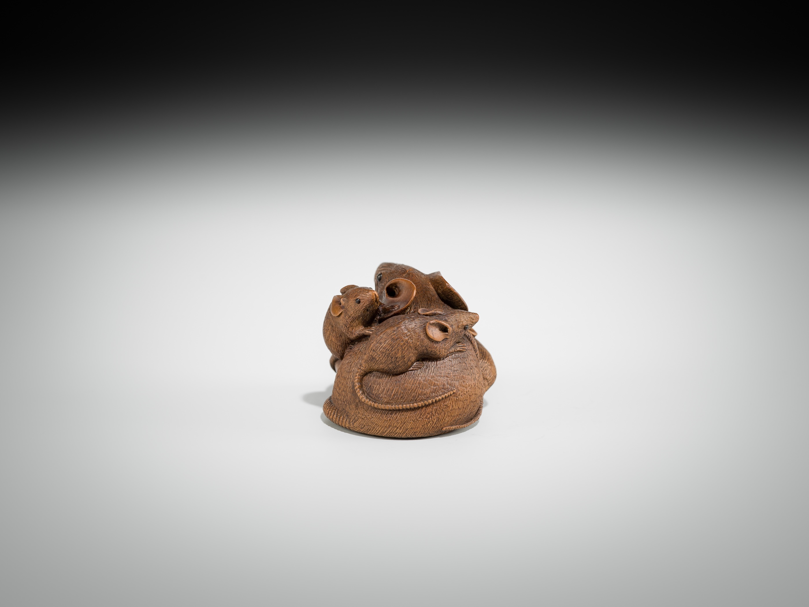 Artwork by Hokyudo Itsumin, ITSUMIN: A FINE WOOD NETSUKE OKIMONO OF A GROUP OF RATS WITH PERSIMMON, Made of wood