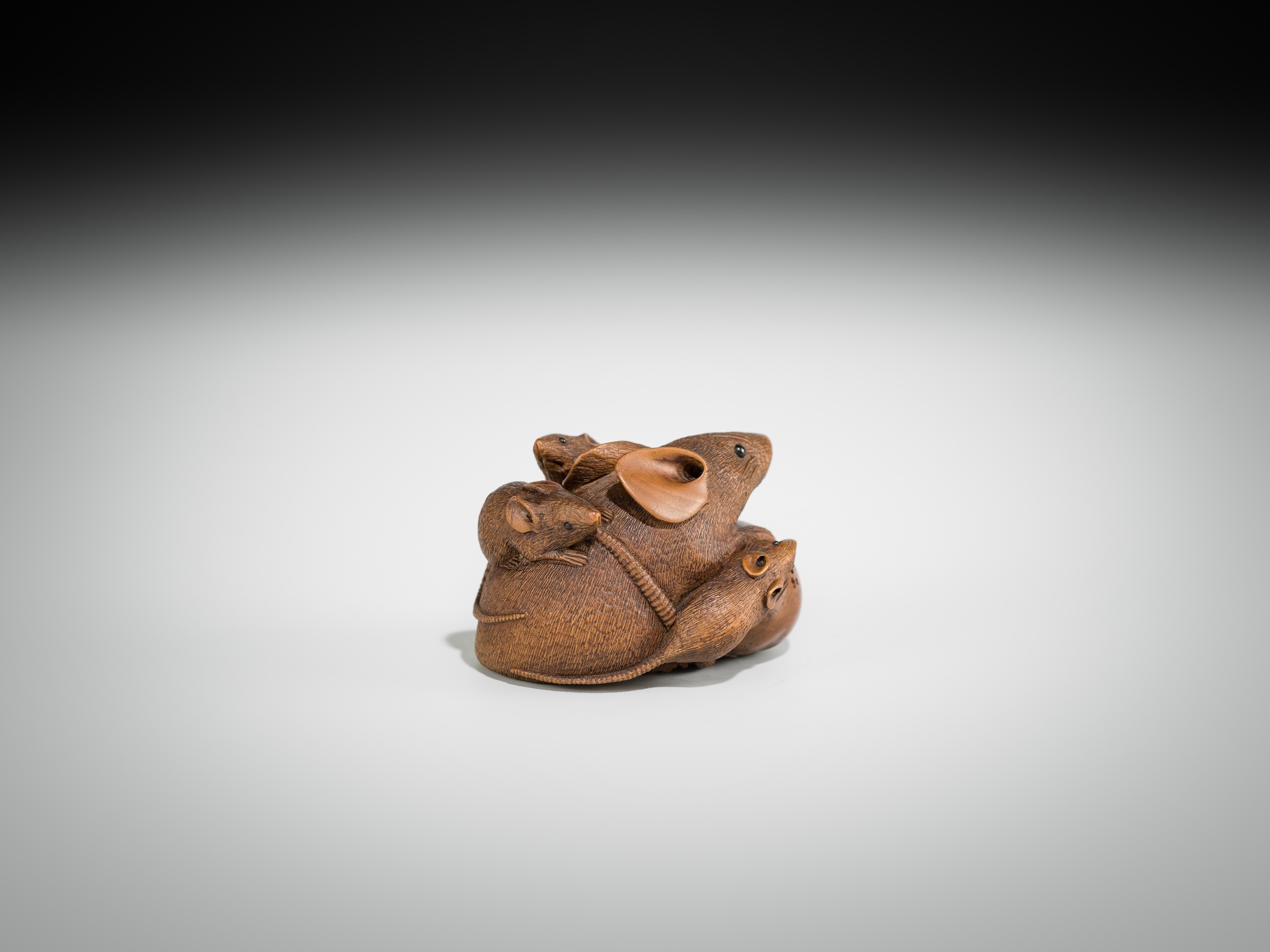 Artwork by Hokyudo Itsumin, ITSUMIN: A FINE WOOD NETSUKE OKIMONO OF A GROUP OF RATS WITH PERSIMMON, Made of wood