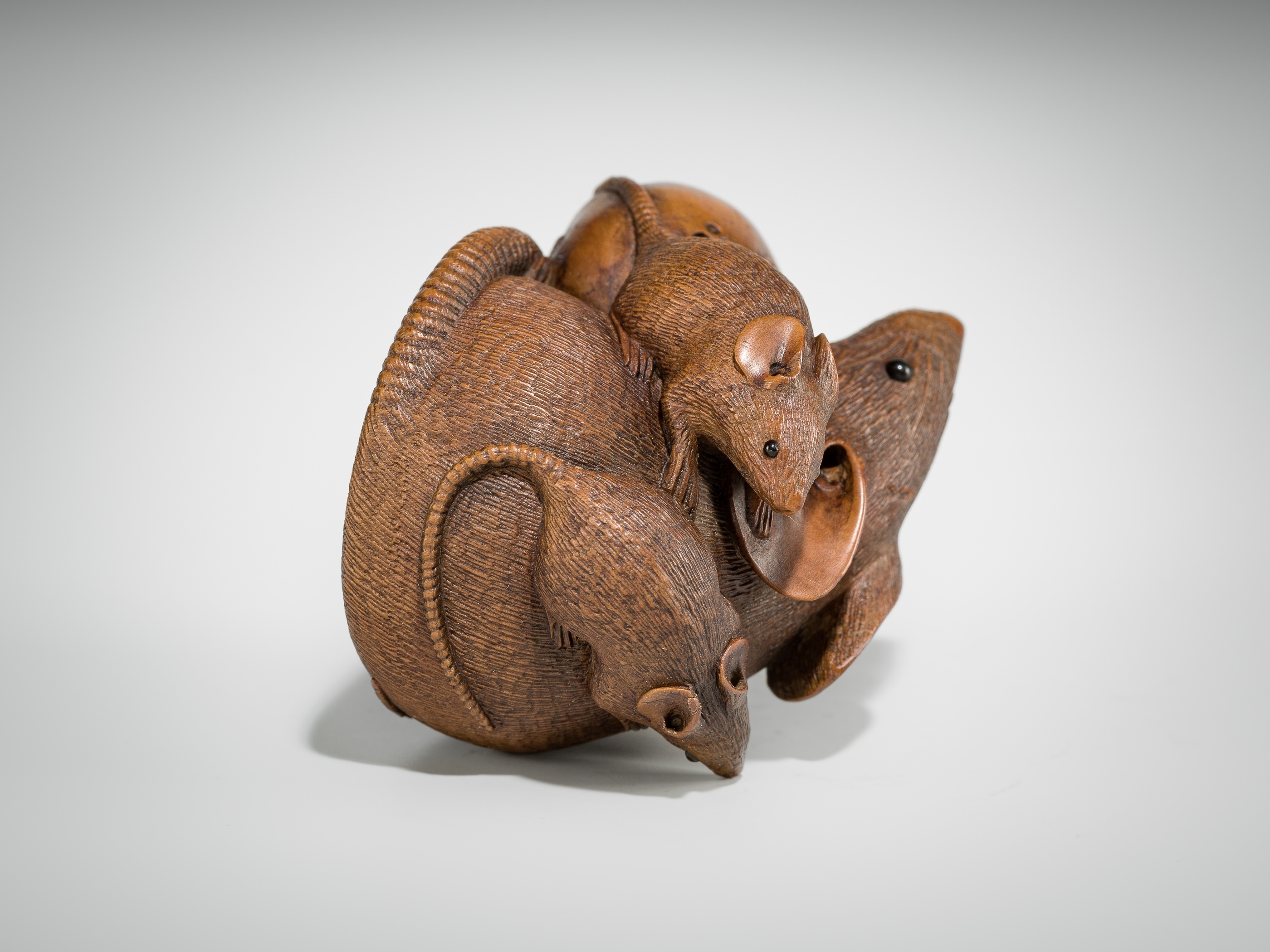 Artwork by Hokyudo Itsumin, ITSUMIN: A FINE WOOD NETSUKE OKIMONO OF A GROUP OF RATS WITH PERSIMMON, Made of wood