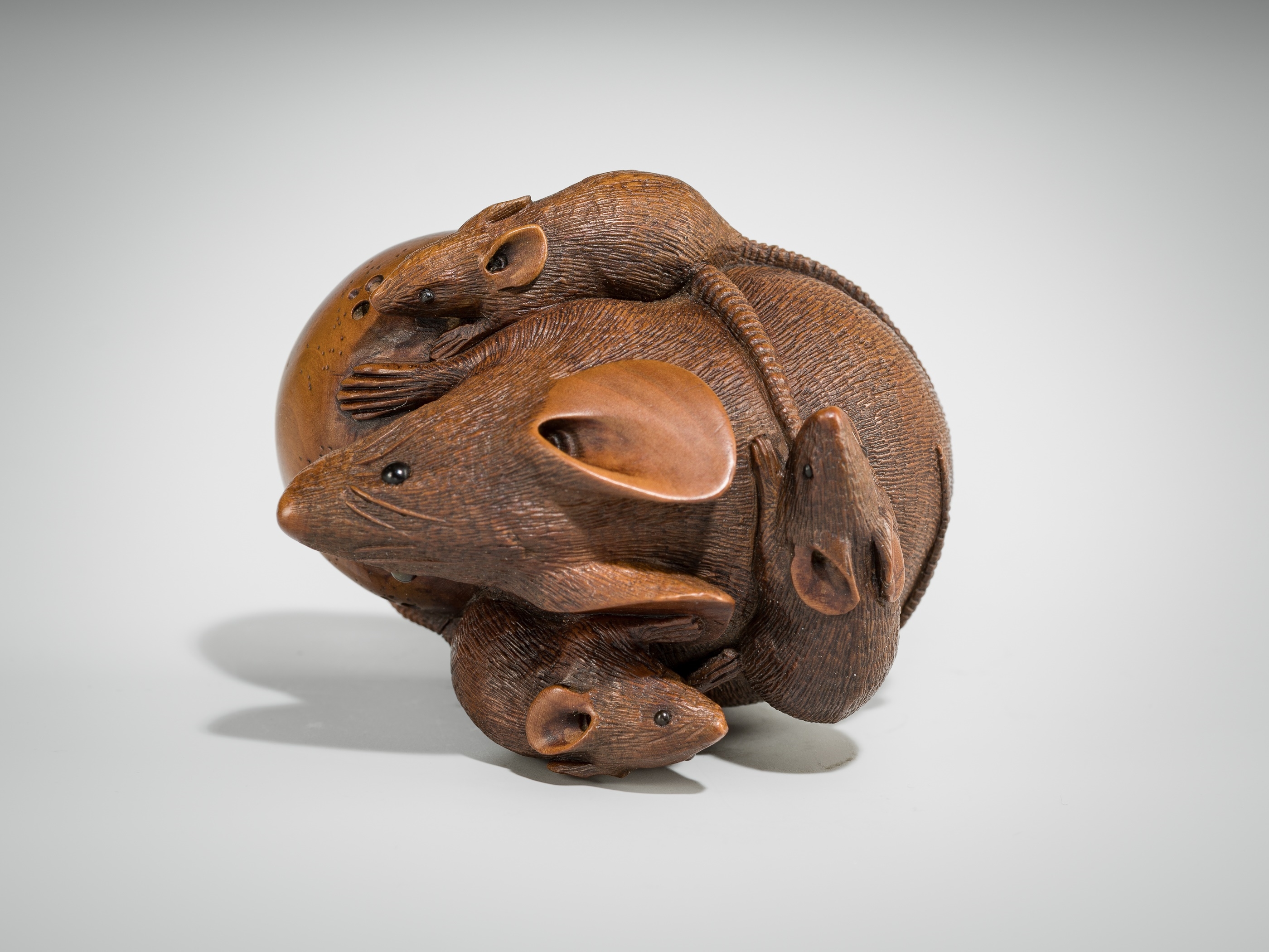 Artwork by Hokyudo Itsumin, ITSUMIN: A FINE WOOD NETSUKE OKIMONO OF A GROUP OF RATS WITH PERSIMMON, Made of wood