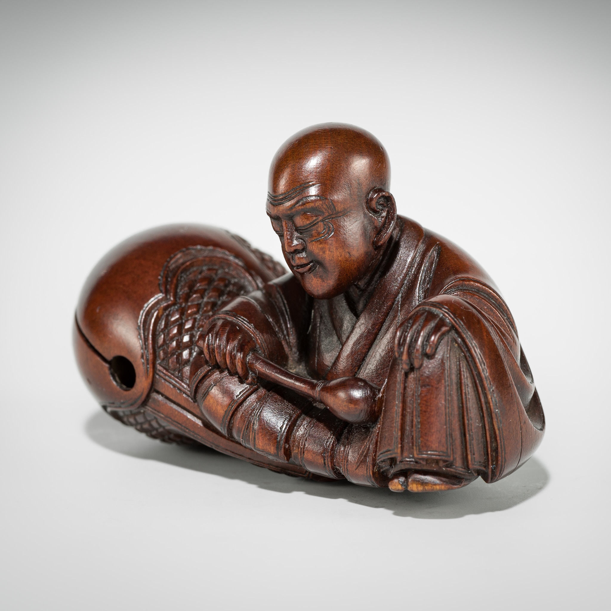 Artwork by Shûmin, SHUMIN: A FINE WOOD NETSUKE OF A MONK WITH MOKUGYO, Made of wood