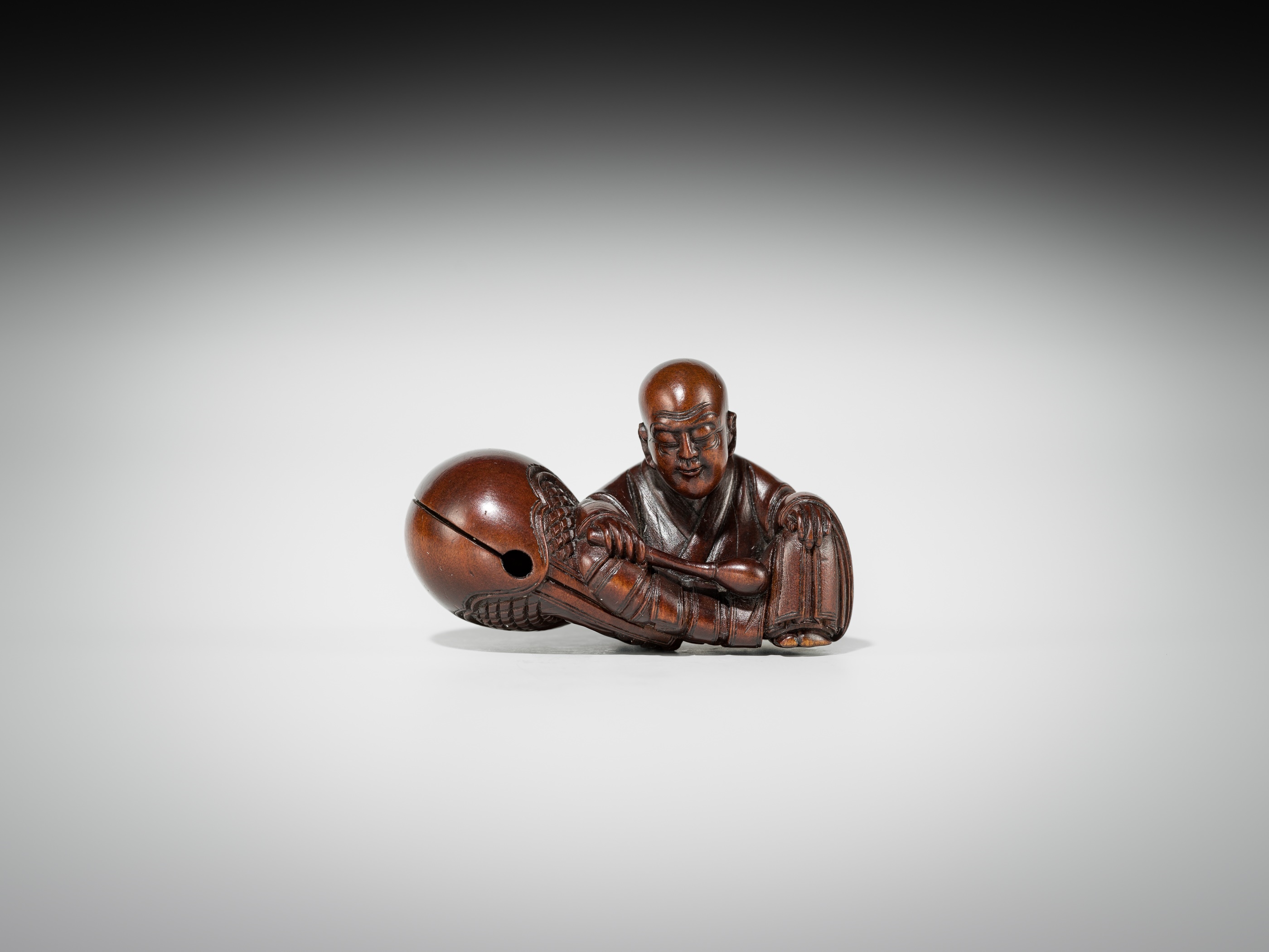 Artwork by Shûmin, SHUMIN: A FINE WOOD NETSUKE OF A MONK WITH MOKUGYO, Made of wood