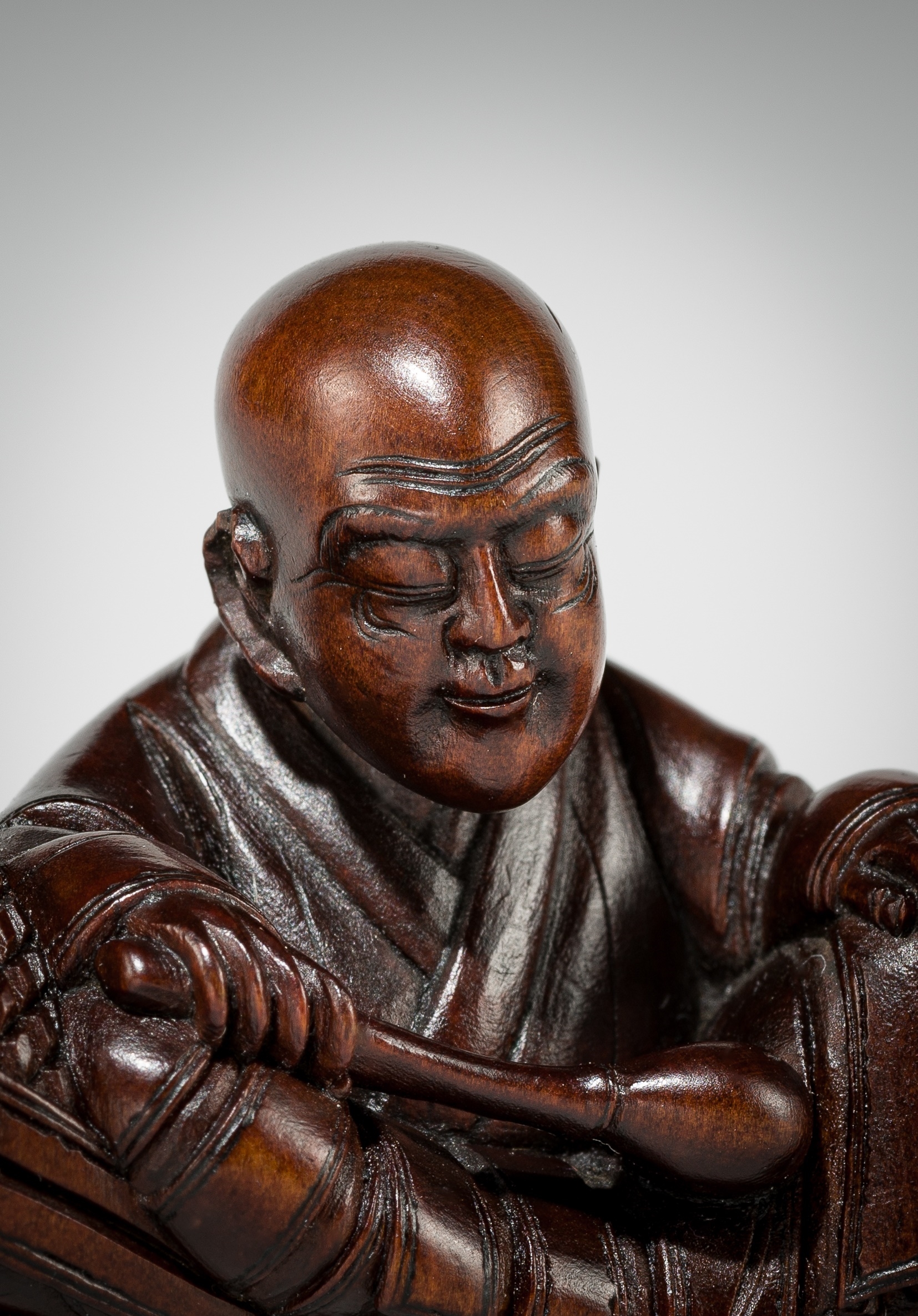 Artwork by Shûmin, SHUMIN: A FINE WOOD NETSUKE OF A MONK WITH MOKUGYO, Made of wood