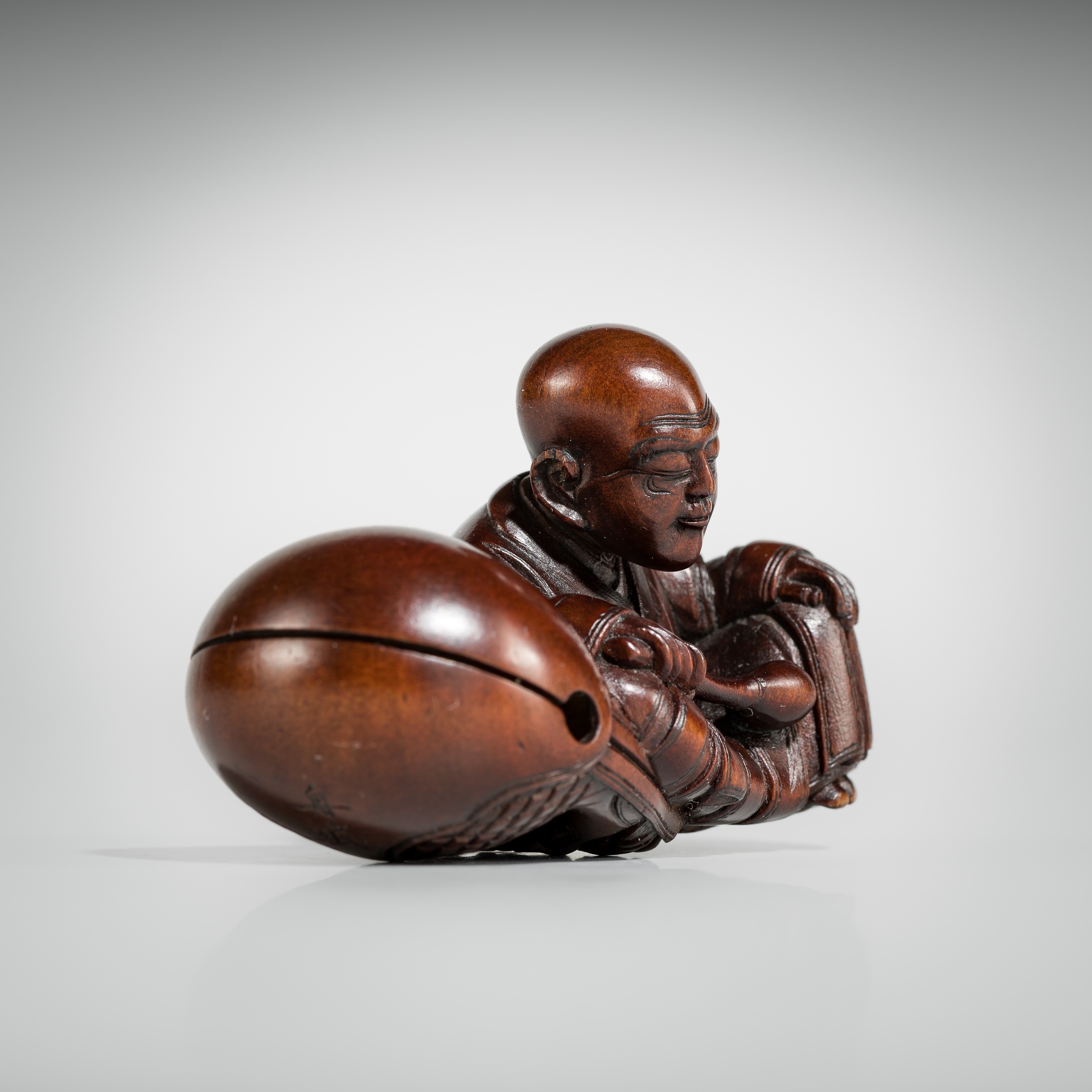 Artwork by Shûmin, SHUMIN: A FINE WOOD NETSUKE OF A MONK WITH MOKUGYO, Made of wood