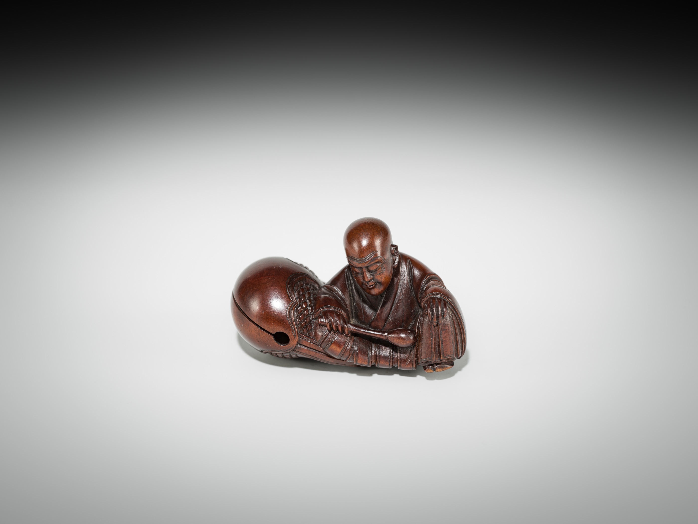 Artwork by Shûmin, SHUMIN: A FINE WOOD NETSUKE OF A MONK WITH MOKUGYO, Made of wood