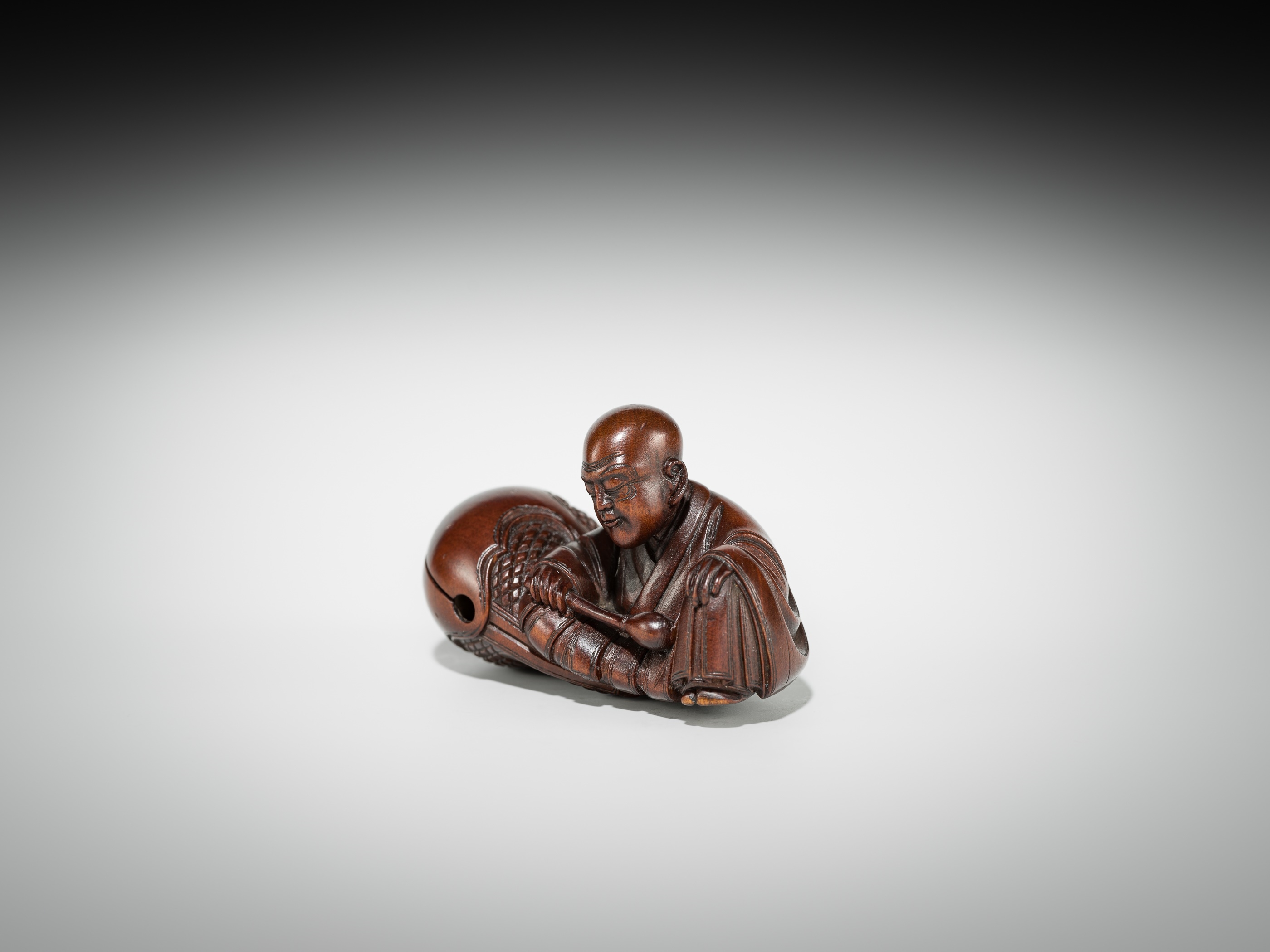 Artwork by Shûmin, SHUMIN: A FINE WOOD NETSUKE OF A MONK WITH MOKUGYO, Made of wood
